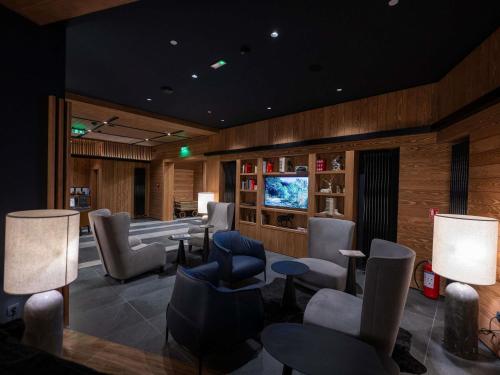 a waiting room with chairs and a flat screen tv at Swissôtel Resort Kolasin in Kolašin