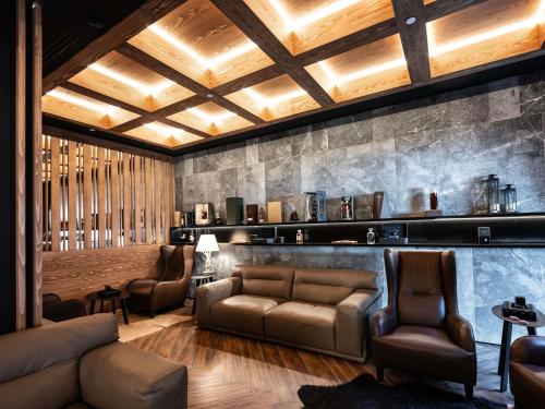 a living room with a couch and chairs at Swissôtel Resort Kolasin in Kolašin