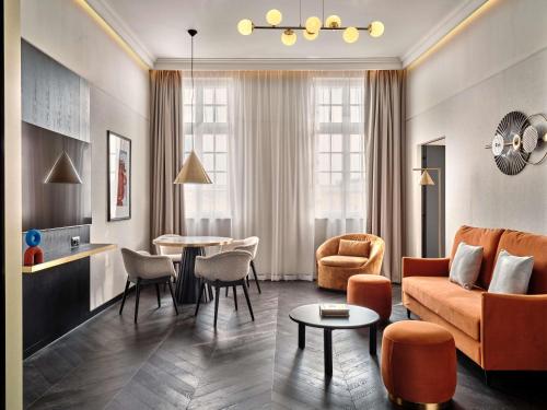 a living room with a couch and a table at Mövenpick Grand Hotel Wroclaw in Wrocław