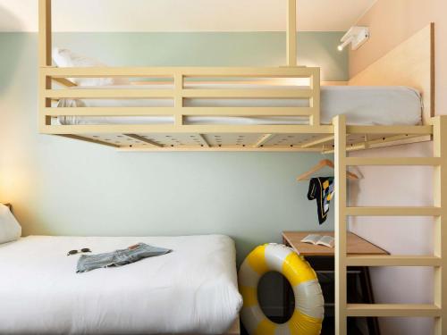 a bedroom with two bunk beds and a volley ball at Greet Hotel Nice Aéroport Promenade des Anglais in Nice