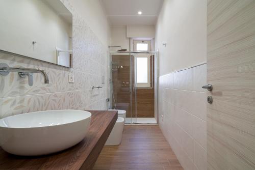 a bathroom with a large white tub and a toilet at Casa degli Oleandri in Giardini Naxos