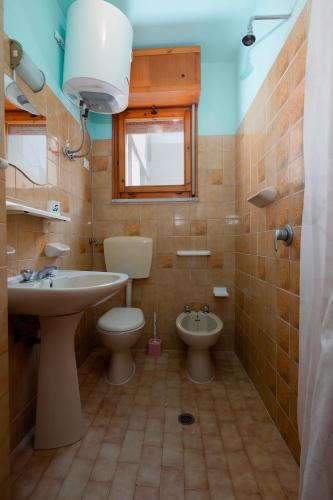 a bathroom with a sink and a toilet and a window at Belvedere in Lido Adriano