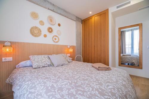 a bedroom with a large bed and a window at CARTAGENAFLATS - San Diego Suites in Cartagena