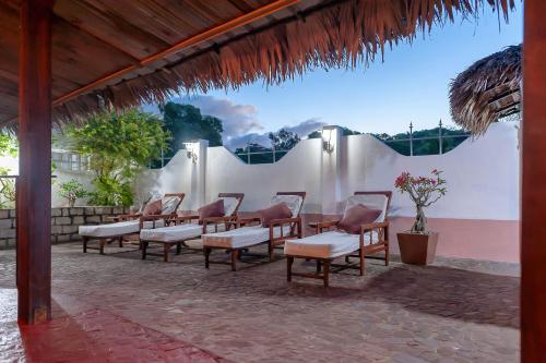 a patio with a bunch of chairs and a table at A casa di Giorgia lodge Nosy be Andilana in Nosy Be