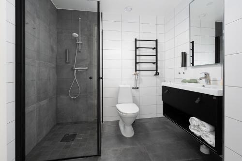 a bathroom with a shower and a toilet and a sink at Sky Hotel City Apartments in Linköping