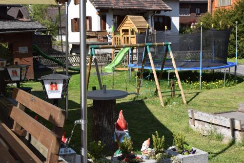a playground in a yard with a swing set at Hotel Restaurant Simplon in Frutigen