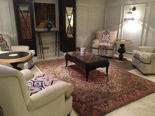 a living room with a coffee table and chairs at Hagia Sofia Mansions Istanbul, Curio Collection by Hilton in Istanbul