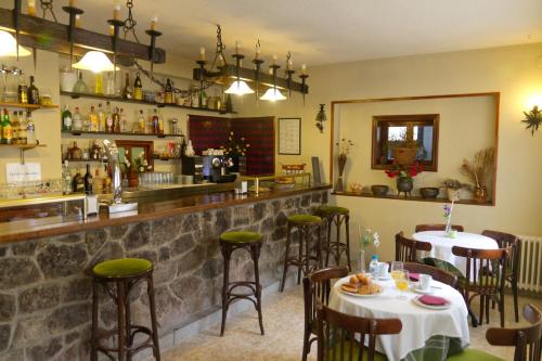 a restaurant with two tables and a bar at Hostal Siete Picos in El Espinar