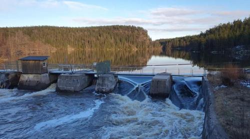 a dam on a body of water with trees in the background at Olletorp in Munkedal