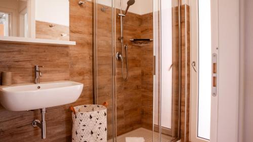 a bathroom with a sink and a shower at Teuladamar by Rentbeat in SantʼAnna Arresi