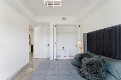 a bedroom with a large bed with pillows on it at Ultra Luxe Apartment in Prime Location in Fort Lauderdale