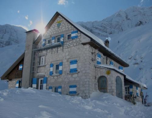 a building on top of a snow covered mountain at Casa JOY in Sella Nevea