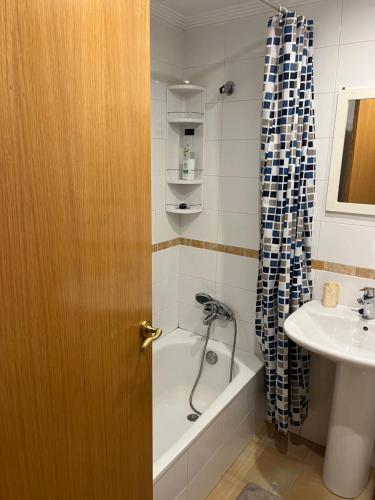 a bathroom with a tub and a sink and a door at MAGIC I a 1 minuto de la Catedral y Plaza Mayor in León