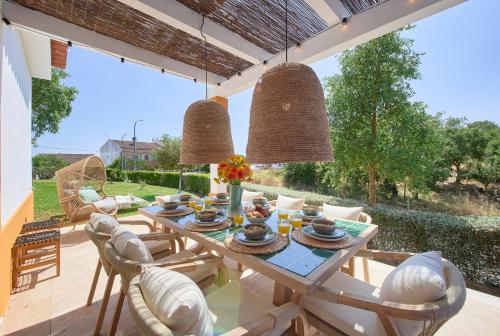 a dining room with a table and chairs at Peaceful Villa by Melides w Pool, by TimeCooler in Santiago do Cacém