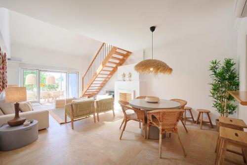a living room with a table and chairs at Peaceful Villa by Melides w Pool, by TimeCooler in Santiago do Cacém