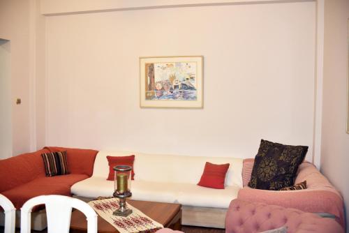 a living room with two couches and a table at Angelica's House in Pythagoreio