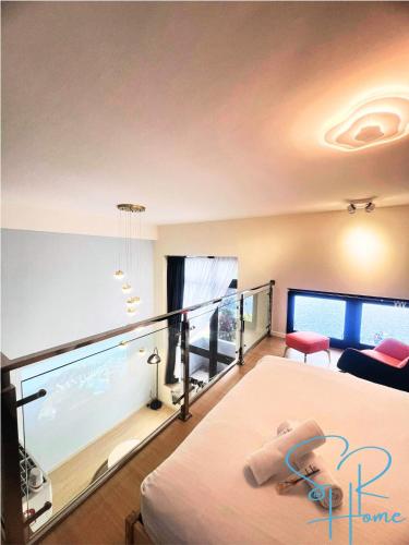 a bedroom with a bed and a balcony with an aquarium at Sunway GRID by SR Home in Kampong Pendas
