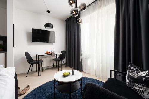 a living room with a couch and a table at Sky Hotel City Apartments in Linköping