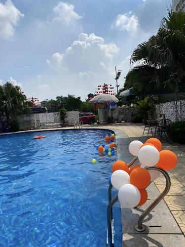 a pool with orange and white balloons in it at Khách sạn Phương Anh in HÆ°ng YÃªn