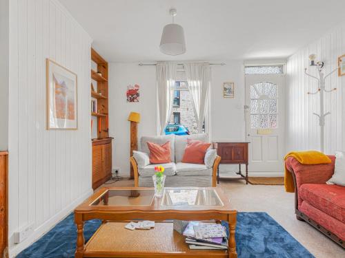 a living room with a couch and a table at Pass the Keys Cosy Garden Home in Canterbury