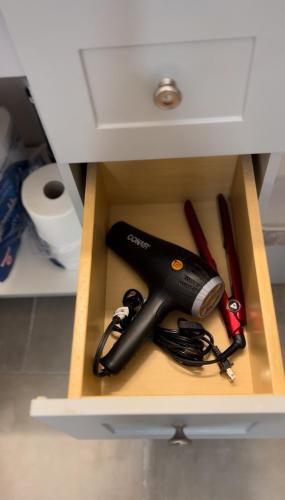 a drawer with a tool in a cabinet at Blissful Nest - Cozy, Classy 2 Bedroom Private Suite Netflix, free Parking, 20 minutes to West Edmonton Mall and Airport in Edmonton