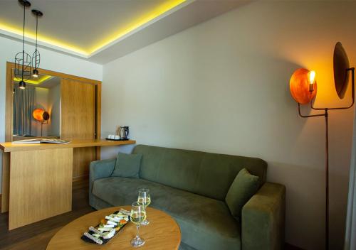 a living room with a couch and a table at Dolce by Wyndham Athens Attica Riviera in Vravrona