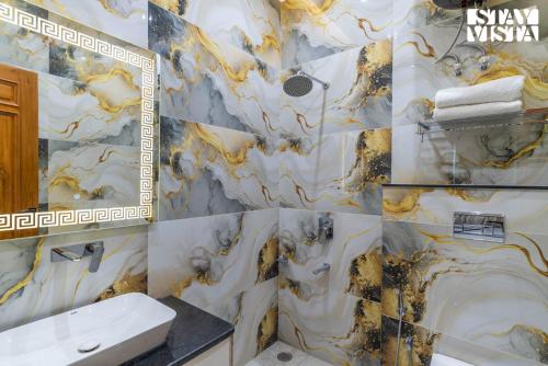 a bathroom with a sink and a marble wall at StayVista at Avanya Retreat with Bonfire, BBQ in Manesar