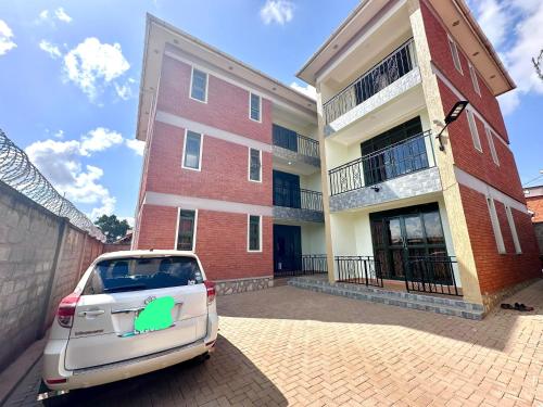 a car parked in front of a brick building at 2Bedroom flat, free Wi-Fi near acacia mall in Nalakonge
