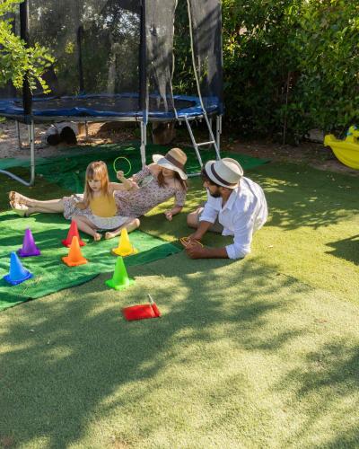 a group of children playing with cones on the grass at Ciriga Sicily Glamping in Santa Maria Del Focallo