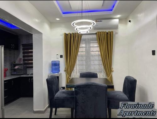 a dining room with a table and chairs at Flowinade Apartment in Ikorodu