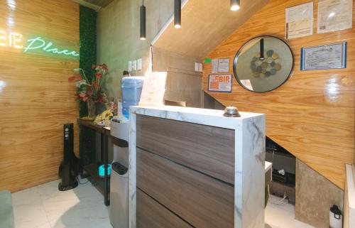 a kitchen with a refrigerator and a clock on the wall at Rcee Place by RedDoorz in Cebu City