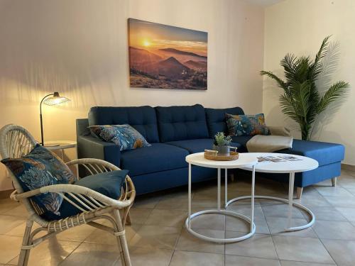 a living room with a blue couch and a table at Kazerna in Hélette