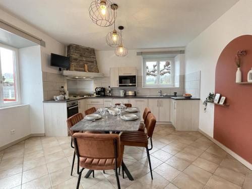 a kitchen and dining room with a table and chairs at Kazerna in Hélette