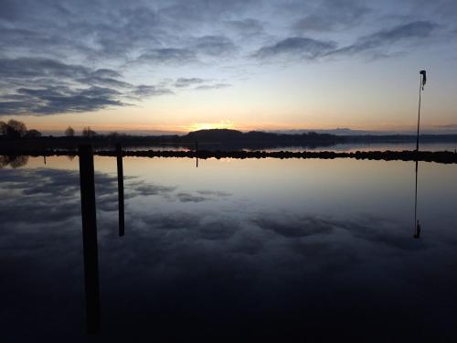 a reflection of the sunset in a body of water at Walls 1 in Wallsbüll