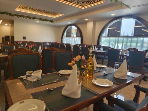 a dining room with a long table and chairs at Hotel YKM Crown in Dehradun