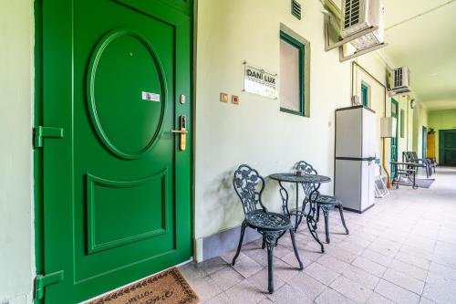 a green door with chairs and a table at Dani Lux by Mital in Szeged