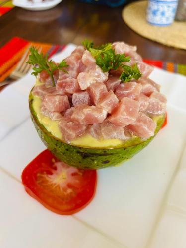 a piece of meat in a melon on a plate at A casa di Giorgia lodge Nosy be Andilana in Nosy Be