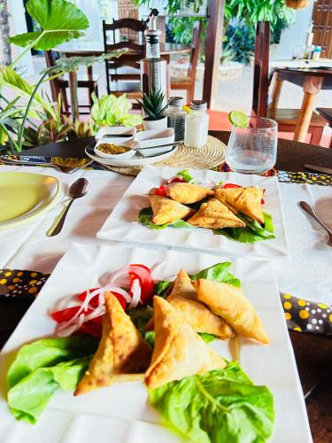 a table with three plates of food on it at A casa di Giorgia lodge Nosy be Andilana in Nosy Be