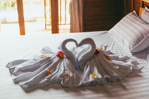 a white dress with a heart on a bed at Loka Sea View Glamping in Pengastulan