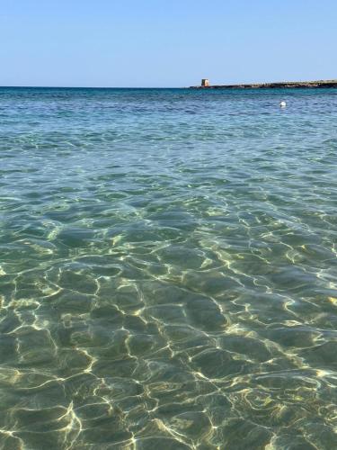 a large body of water with rocks in it at Madre Terra Airport Apartment & Rooms in Terrasini