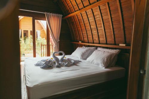 a bedroom with a bed with a towel on it at Loka Sea View Glamping in Pengastulan