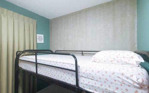 a hospital bed in a hospital room with avertisementatronatronatron at Rcee Place by RedDoorz in Cebu City