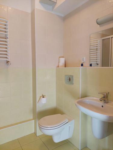a bathroom with a toilet and a sink at Dom Studencki Rubin in Kalisz