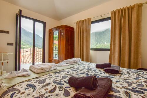 a bedroom with a large bed with a large window at A Casa da Graça Reis by Horizon View Madeira in São Vicente