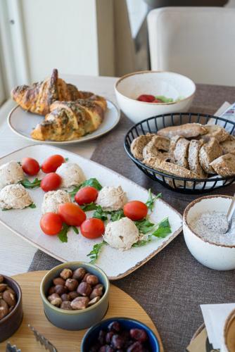 a table with plates of food and bowls of food at Hotel Aria in Podstrana
