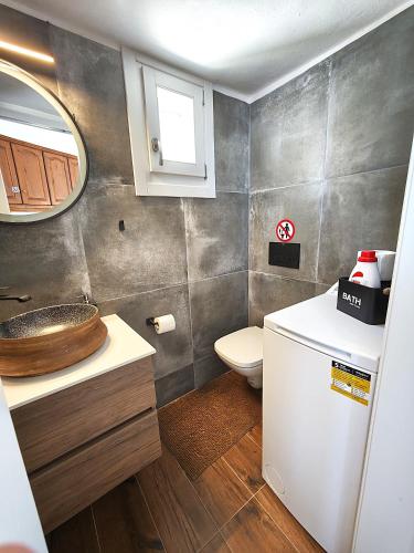 a bathroom with a sink and a toilet at Aggelos & Melina studios - Enjoy sunset from Melina in Ioulida