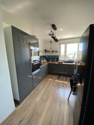 Il comprend une cuisine dotée de parquet et d'une cuisinière. dans l'établissement Joli T3, tout confort, Martigues, à Martigues