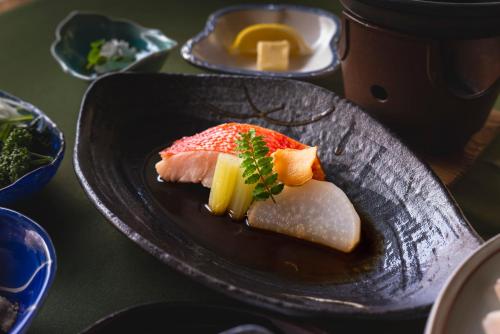 a plate of food with sushi on a table at Le Nessa Jyogasaki in Ito