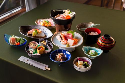 a group of bowls of food on a table at Le Nessa Jyogasaki in Ito
