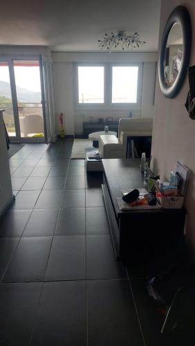 a living room with a large tile floor at Sweet home avec vue incroyable lac leman proche lausanne in Belmont-sur-Lausanne